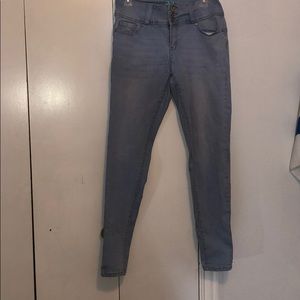 A pair of light washed skinny jeans